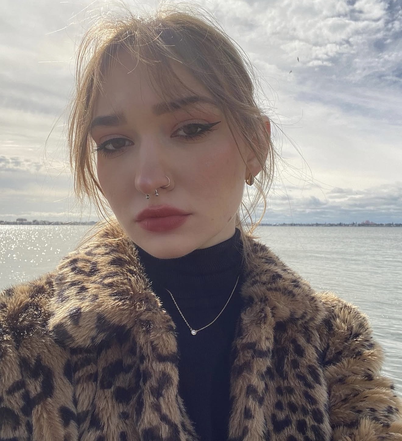 Anastasiya in a leopard print fur coat by the water